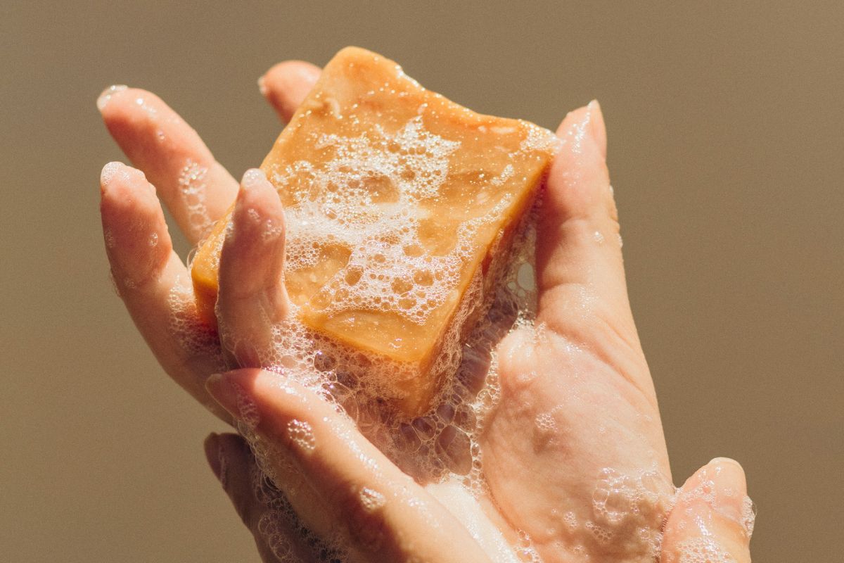 The woman uses a natural soap base when bathing.