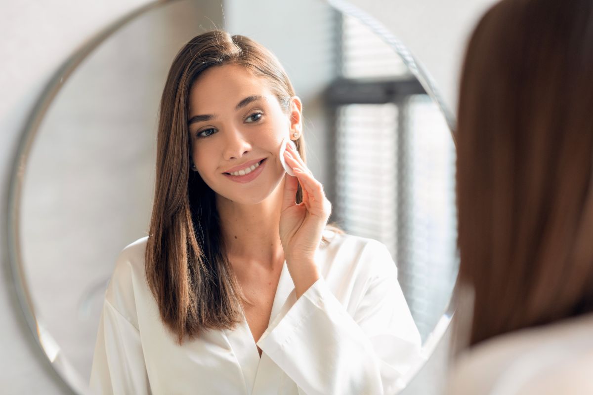 The woman wiped the dirt off her face with turmeric cleansing pads.