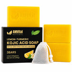 Three yellow AMVital Natural lemon-turmeric kojic acid soap bars, a black branded box, and a white mesh drawstring soap bag on a white background.