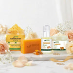 Amvital Turmeric skincare products including scrub, serum, and cream on a white surface with flowers.