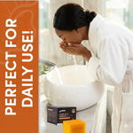 women washing her face using amvital soap