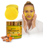 Woman applying a yellow facial mask with a jar of AmVital Turmeric & Kojic Acid pads and turmeric roots on a white background.