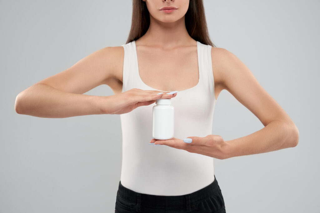 female-holding-small-bottle-medicine