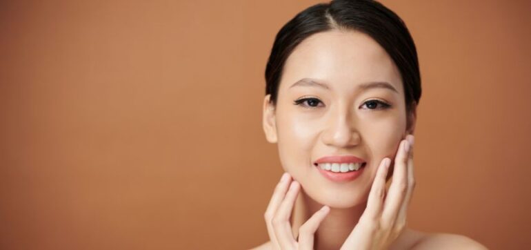 The woman uses kojic acid to brighten her skin.