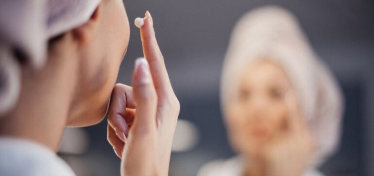 The woman applies wrinkle cream after taking a bath.