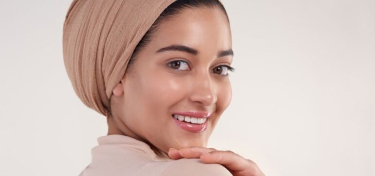 The woman has healthy skin because of using turmeric skin brightening serum.