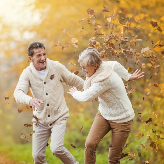 An elderly couple playing together vibrant with health.