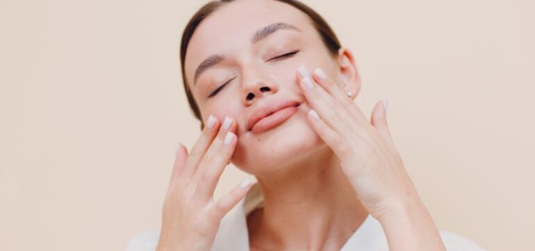 The woman is using turmeric face cream.