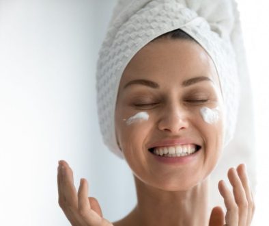 The woman is happy to use vegan skincare products.