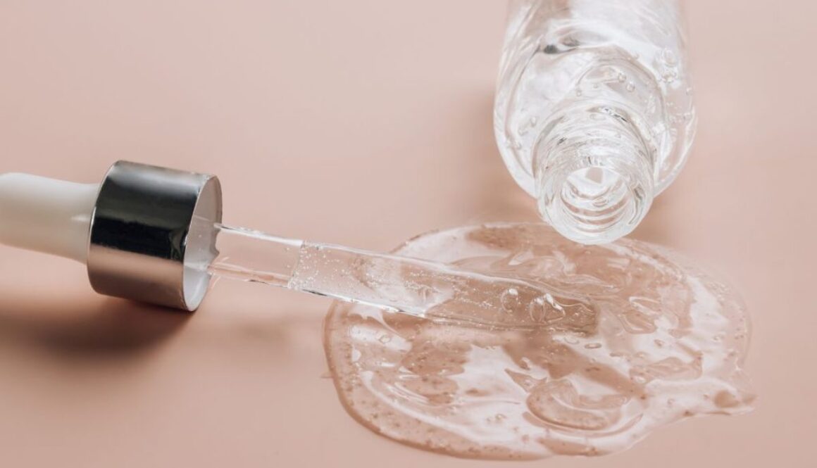 A bottle of hyaluronic acid spilled on the table.