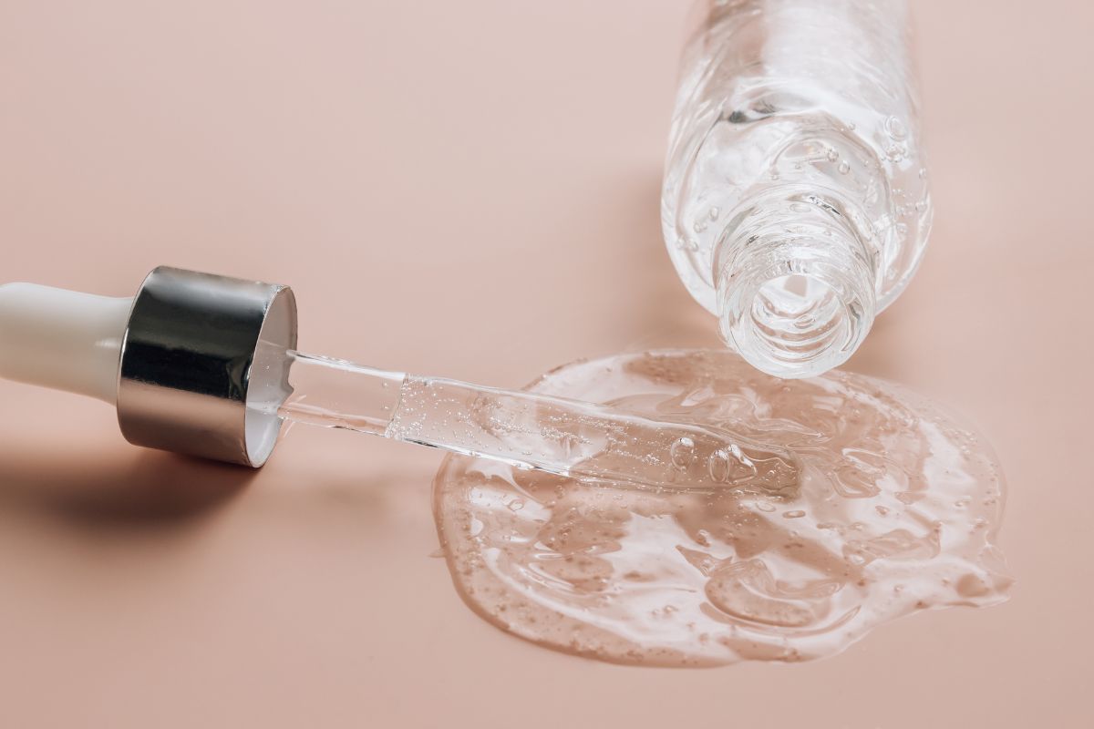 A bottle of hyaluronic acid spilled on the table.