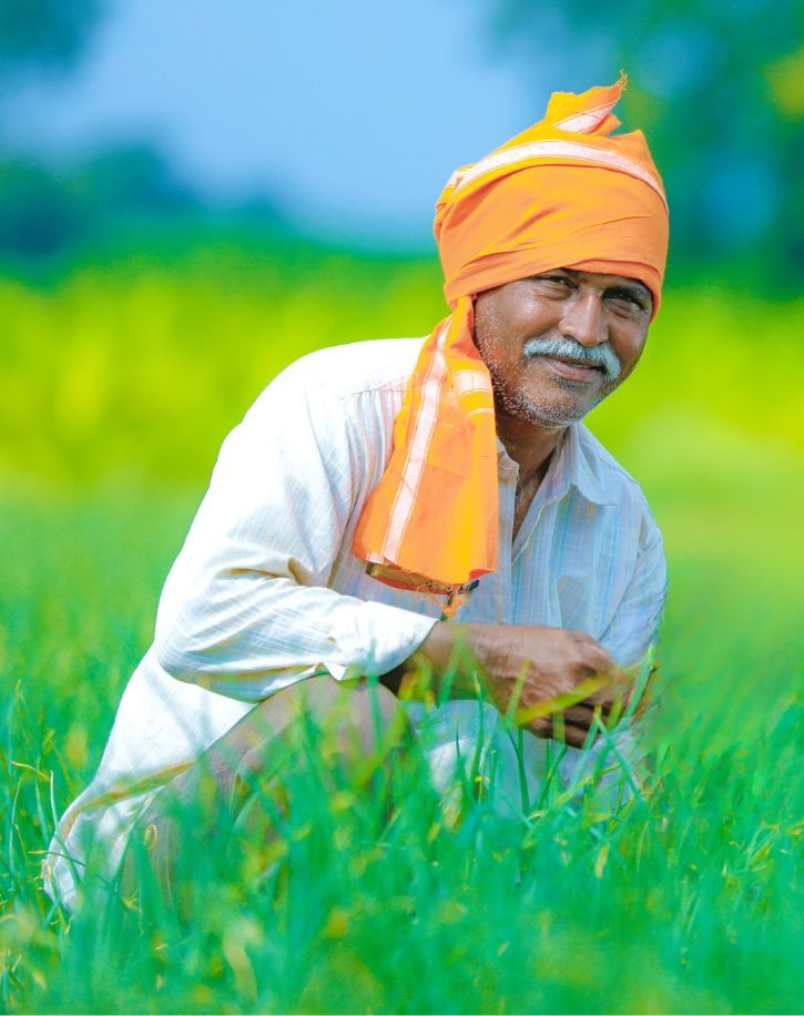 A turmeric root farmer smiling for the camera.