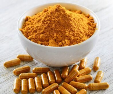 A bowl of turmeric and supplements.