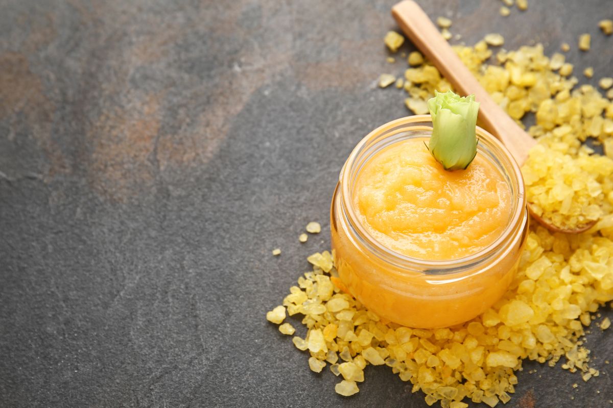 turmeric body scrub (1) A jar of turmeric body scrub.